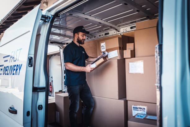 Young man checking a list of packages one more time.